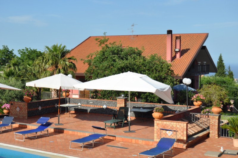Sun loungers by the pool of Villa Del Sole in Zafferana